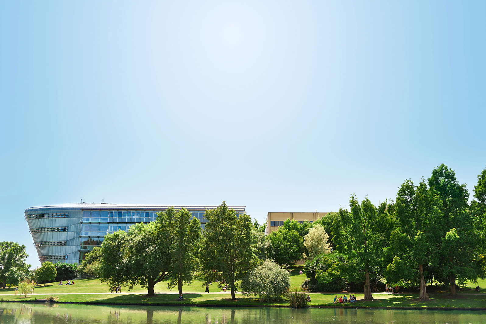 University of Surrey Duke of Kent building viewed across the lake
